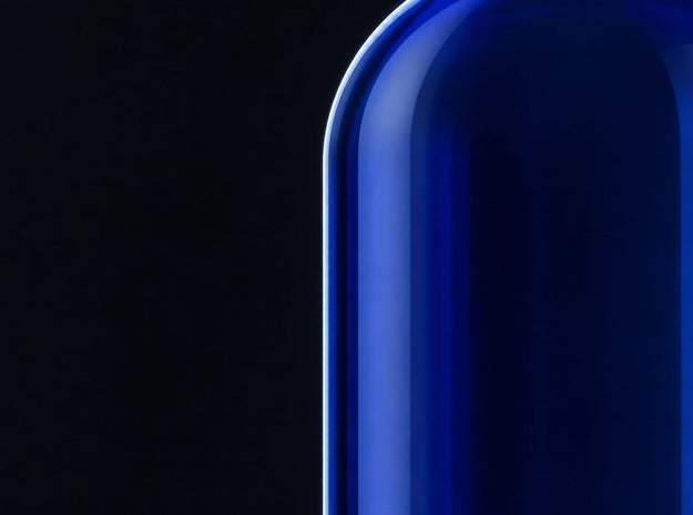 Cobalt glass bottle shoulder on a black background