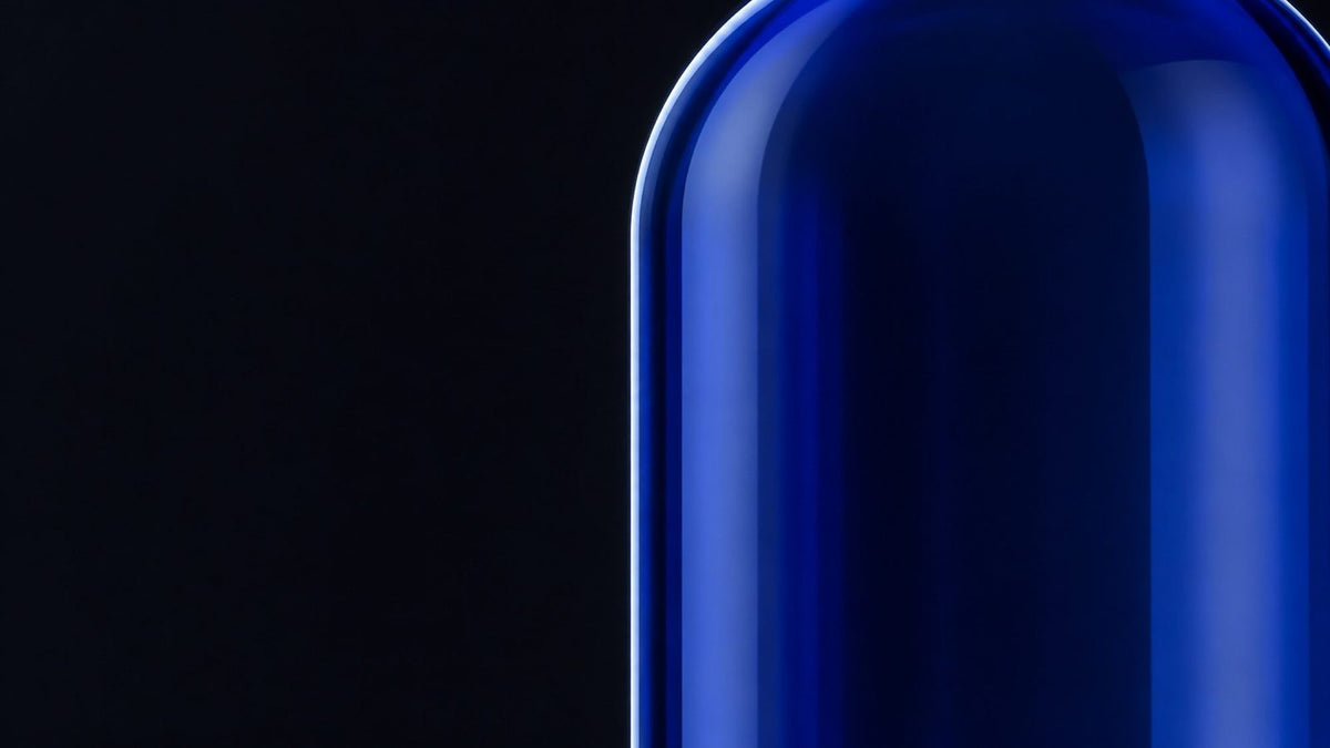 Cobalt glass bottle shoulder on a black background