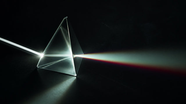 Light refracting through a prism into a controlled spectrum
