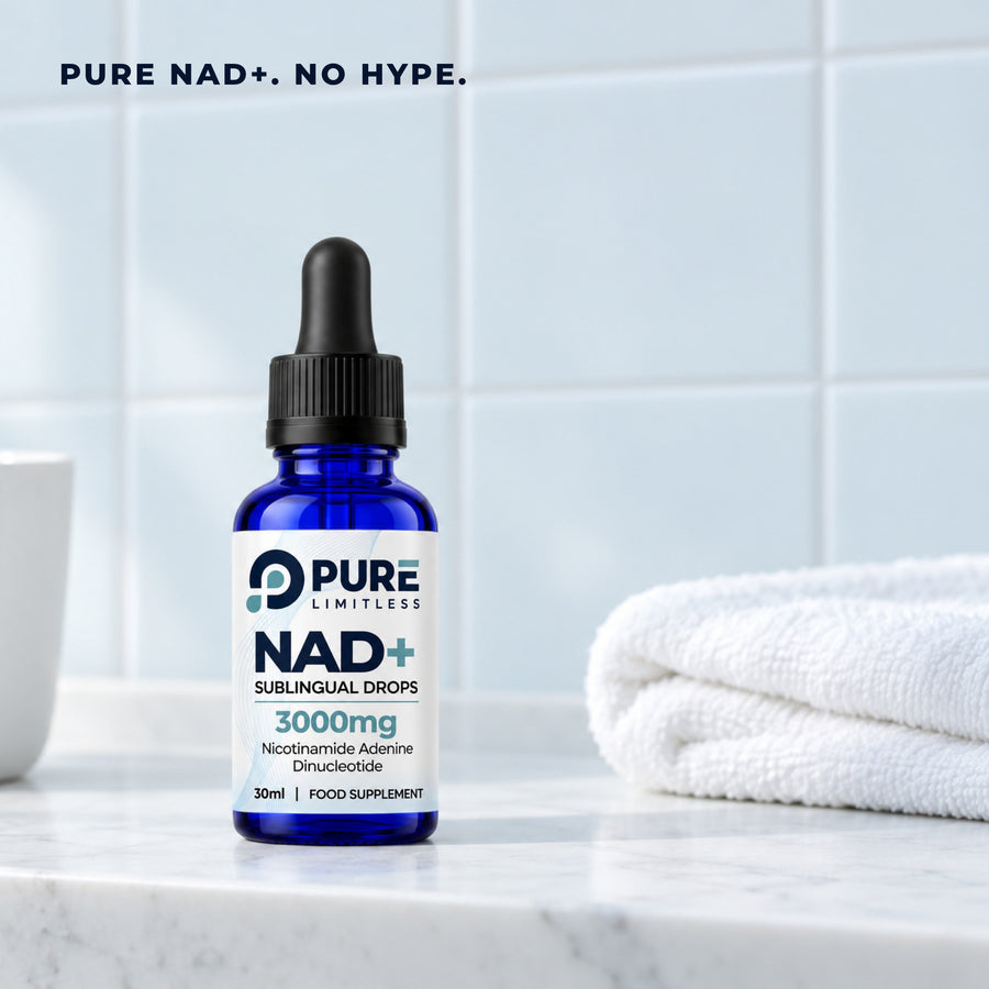 Pure Limitless NAD+ Sublingual Drops bottle on a marble bathroom shelf beside a folded white towel